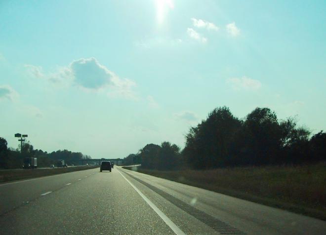 Looking out of the windshield at a freeway.