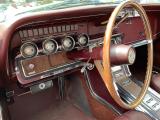 An old car with a dashboard with terrible ergonomics.